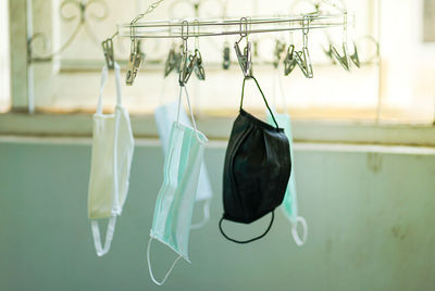 Close-up of clothes drying against wall