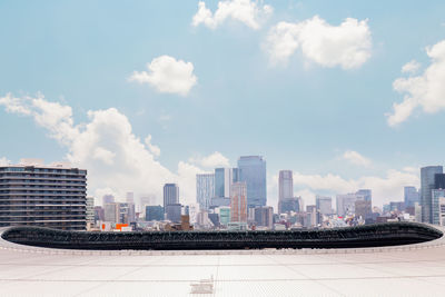 Aerial shot dense tokyo city buildings over shinjuku city, tokyo olympic stadium