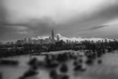 View of city buildings against cloudy sky