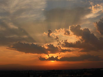 Scenic view of dramatic sky over sea during sunset