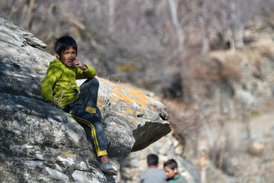 Portrait of boy standing on rock