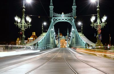 Illuminated liberty bridge against sky at night