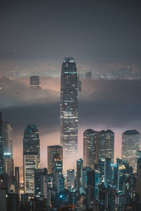 Illuminated cityscape against sky at night