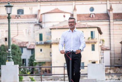 Full length of man standing by building in city