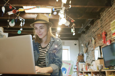 Portrait of young woman using mobile phone