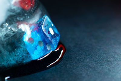 Close-up of reflection on glass against blue background