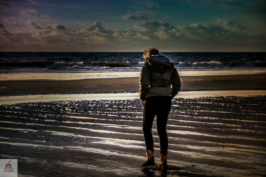 sea, beach, horizon over water, water, sky, standing, rear view, shore, lifestyles, full length, leisure activity, sunset, scenics, sand, tranquility, tranquil scene, casual clothing, cloud - sky