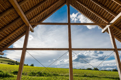 Barn on field against sky