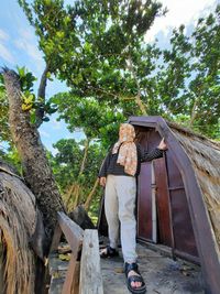 Girl standing on wooden house