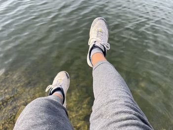 Low section of man swimming in lake