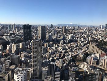 High angle view of modern buildings in city against clear sky