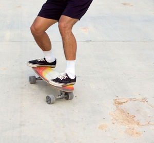 Low section of man skateboarding on skateboard