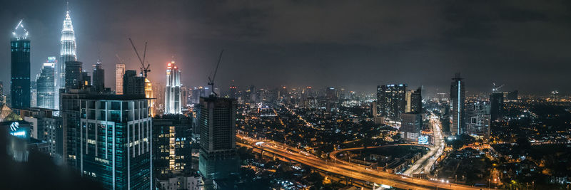 Aerial view of city lit up at night