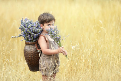 Portrait of woman standing on field