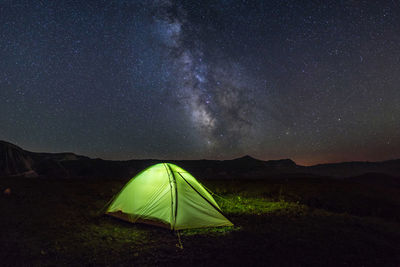 View of the tent and the milky way in the mountains