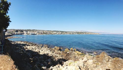 Scenic view of sea against clear blue sky