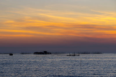 Scenic view of sea against orange sky