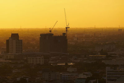 Buildings in city against sky during sunset