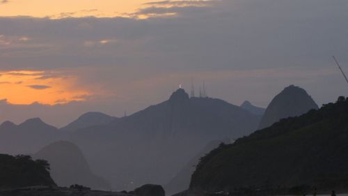 Scenic view of mountains against cloudy sky