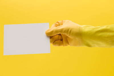 Cropped hand of woman holding paper