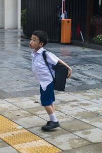 Full length of boy with arms raised