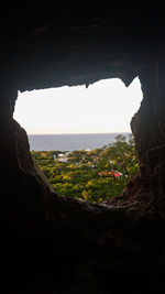 Scenic view of sea seen through cave