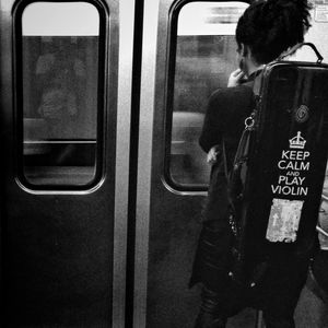 Rear view of people sitting in train