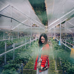 Woman standing in greenhouse