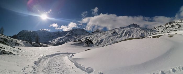 Scenic view of snowcapped mountains against sky