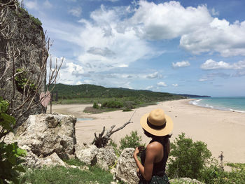 Rear view of woman looking at sea against sky