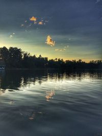 Scenic view of lake against sky at sunset