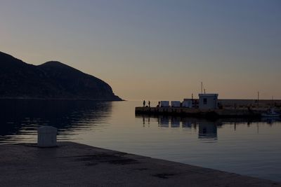 Pier over sea against sky during sunset