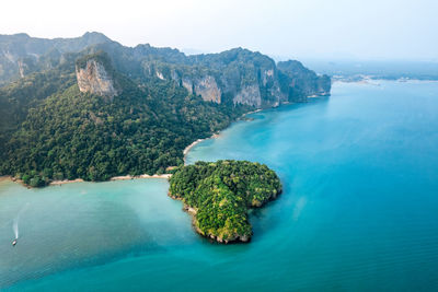 Scenic view of sea and mountains against sky