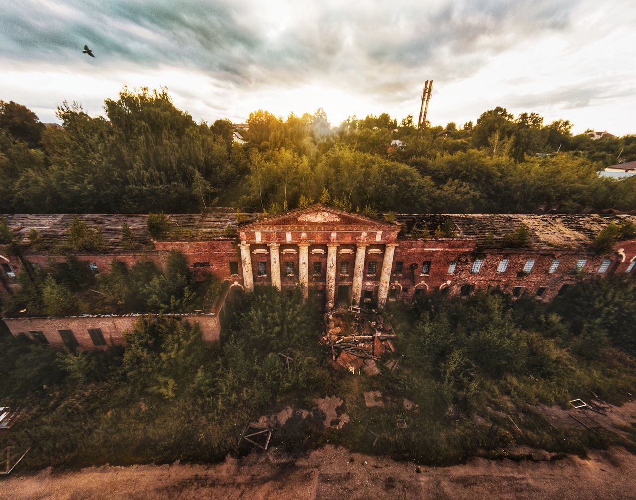 BUILT STRUCTURE AND TREES ON BRIDGE AGAINST SKY