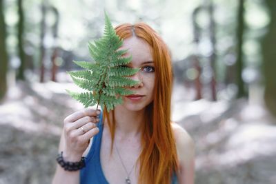 Portrait of young woman with leaves