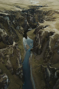 High angle view of stream flowing through rocks