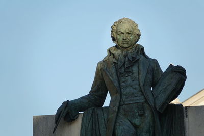 Low angle view of statue against sky