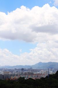 View of town against cloudy sky