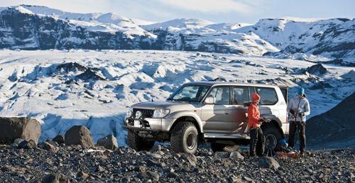 Young couple getting ready to hike from their suv in iceland