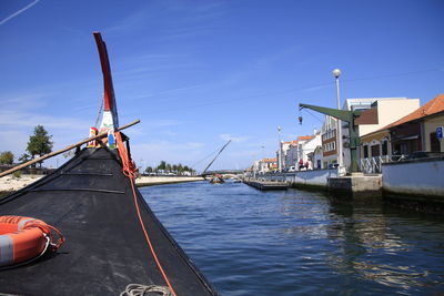 Ship moored on shore against sky