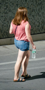 Full length of woman standing by railing