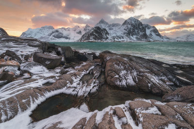 Scenic view of snowcapped mountains against sky during sunset