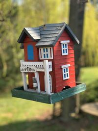 Close-up of birdhouse on house against building
