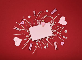 High angle view of heart shape decoration on red table