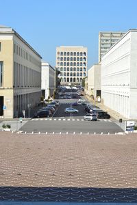City street and buildings against sky