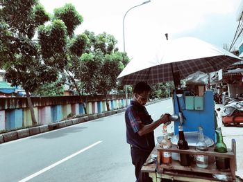 Side view of man standing on road