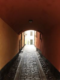 Empty alley amidst buildings in city