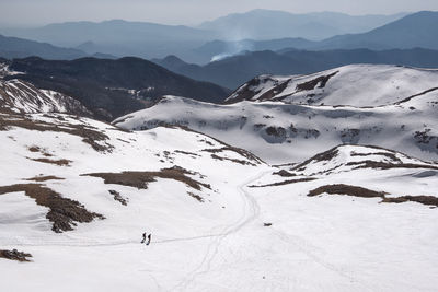 Scenic view of snow covered mountains against sky