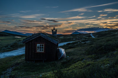 House at smuksjøseter fjellstue at sunset, blåhøe 1617 meter in horisont