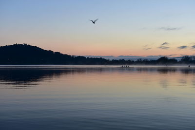 Scenic view of lake against sky during sunset